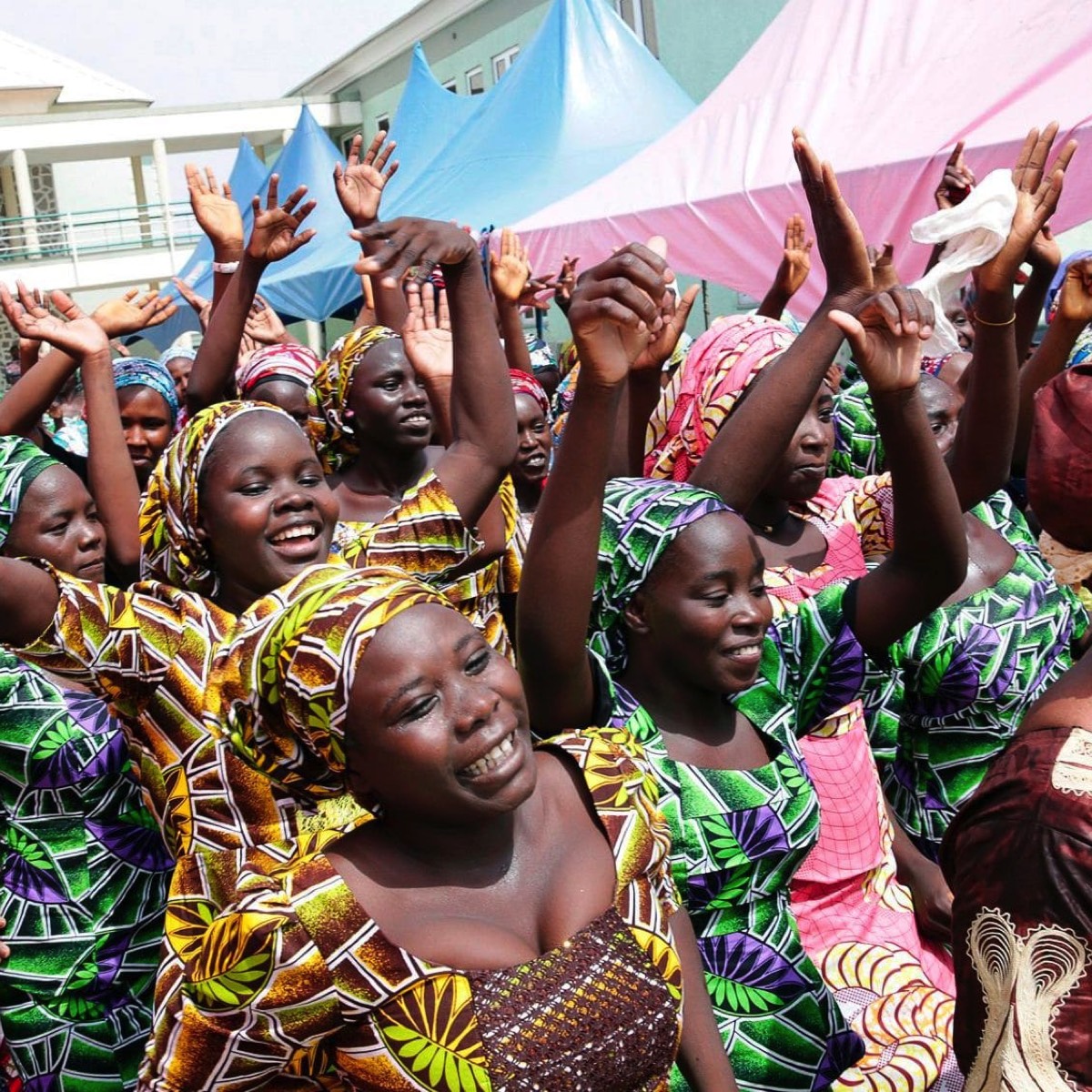 Some of the released girls celebrate before being reunited with their families [Photo: Sunday Aghaeze/AFP]